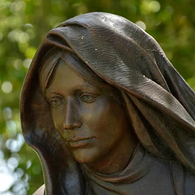 close-up view of bronze Virgin Mary Lawn Statue with hooded robe
