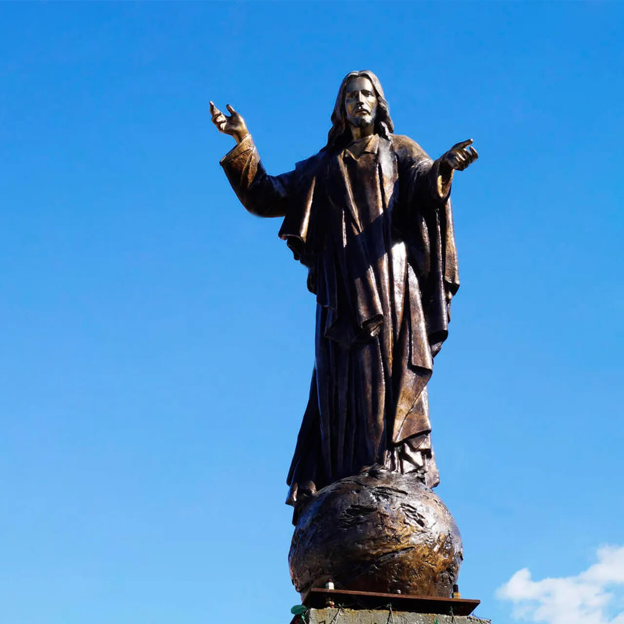 outdoor Bronze Statue of Jesus standing on a globe with raised hands