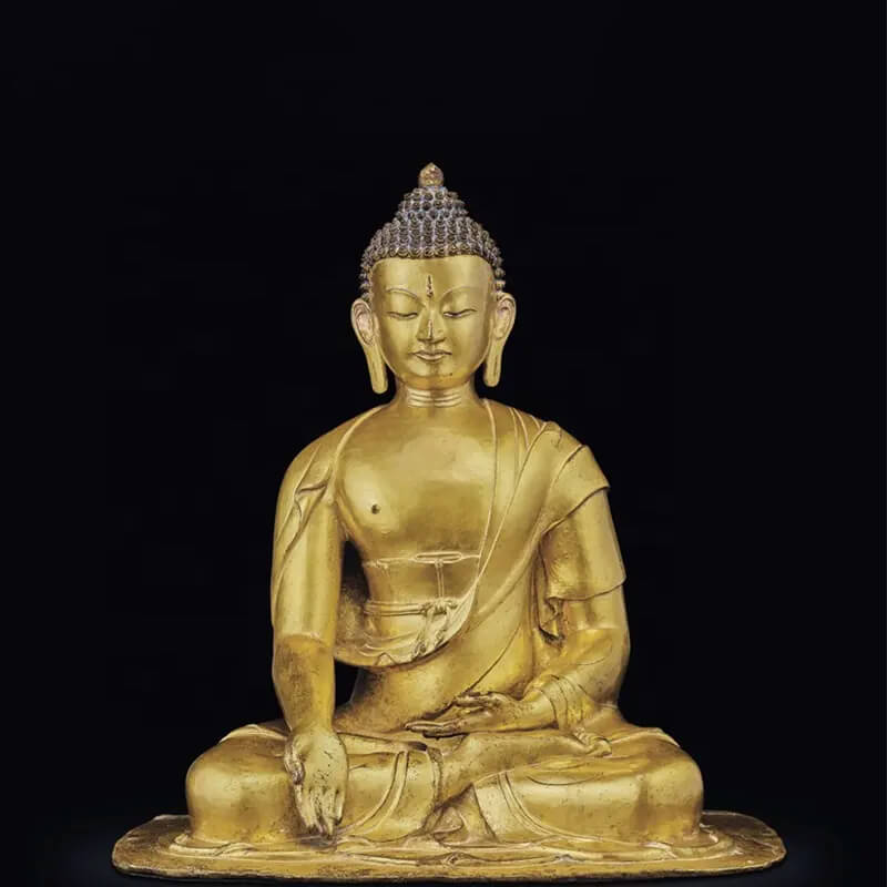A gild bronze Seated Shakyamuni Buddha with right hand in bhumisparsha mudra and serene expression