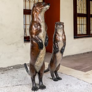 A pair of bronze Otter Lawn Ornaments of river otters