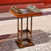 Bronze Chess Board sculpture with bronze African animal chess pieces on a wooden board and tall wood pedesta