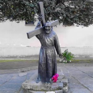 Bronze Padre Pio Garden Statue showing Saint Pio wearing a Franciscan robe and carrying a large cross