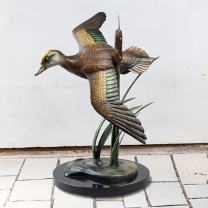Flying Duck Garden Ornament featuring a bronze American Wigeon in mid-flight with spread wings and naturalistic coloring