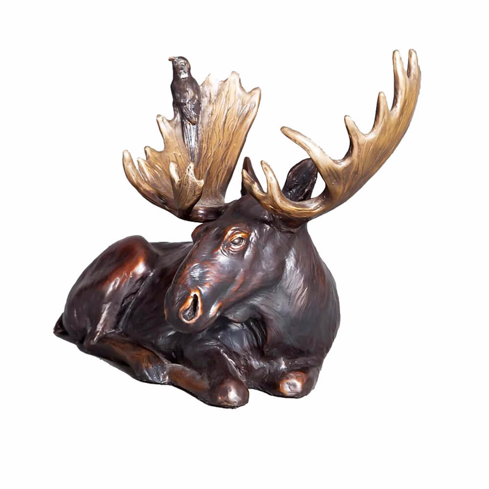 Lifelike bronze Moose Yard Statue featuring a reclining moose with a bird perched on its antlers