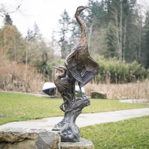Outdoor Blue Heron Bronze Sculptures featuring a standing and resting heron