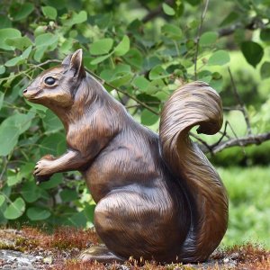 Outdoor Squirrel Statue in bronze showing a lifelike squirrel with curled tail holding an acorn