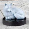 bronze Arctic Fox Statue featuring a minimalist white fox curled on a black marble base