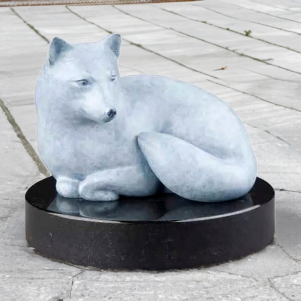 bronze Arctic Fox Statue featuring a minimalist white fox curled on a black marble base