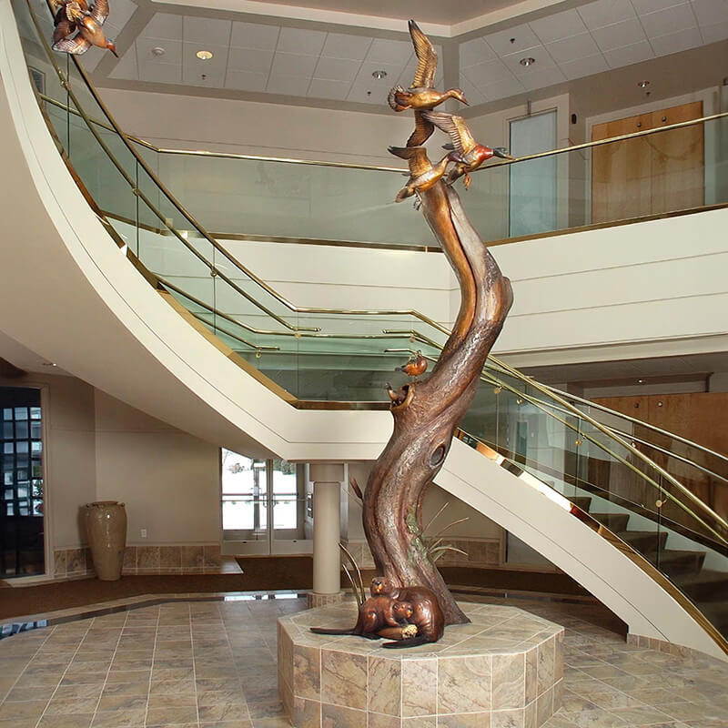 bronze Mallard Statue featuring ducks in motion and lifelike beavers at the root