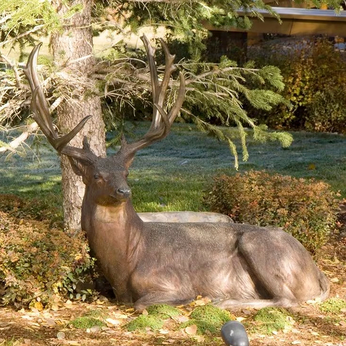 realistic bronze Garden Stag Sculpture featuring a seated mule deer