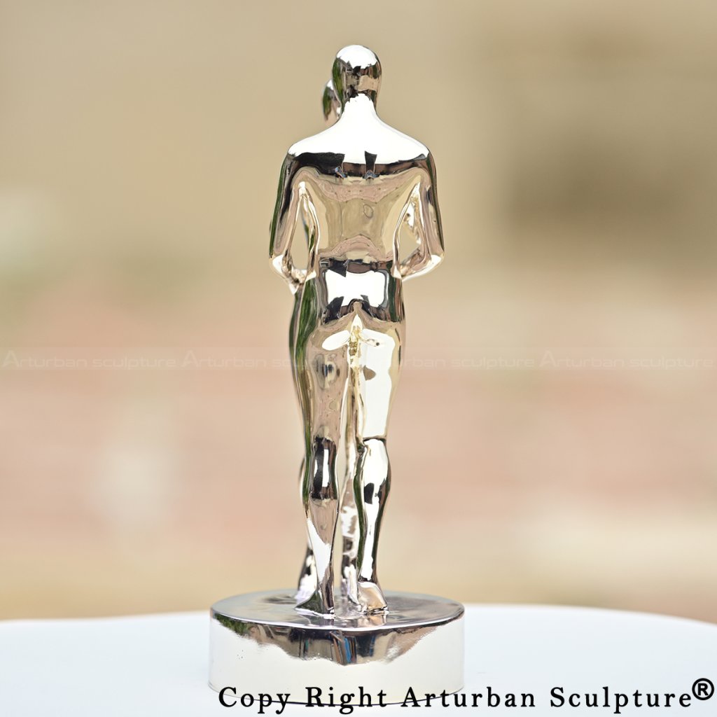 Couple embracing statue in shiny stainless steel, representing In Every Lifetime I Will Find You