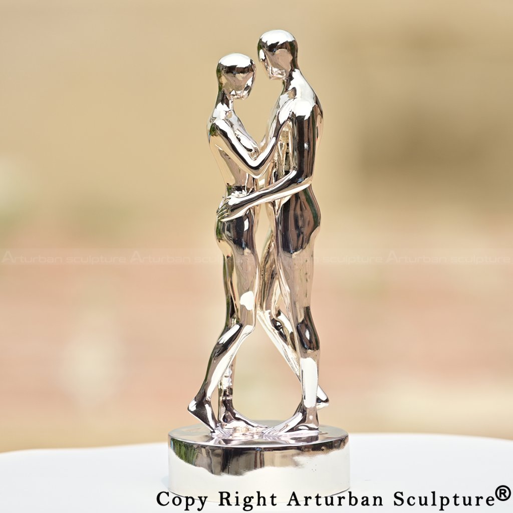 couple embracing statue titled In Every Lifetime I Will Find You, reflective metallic surface