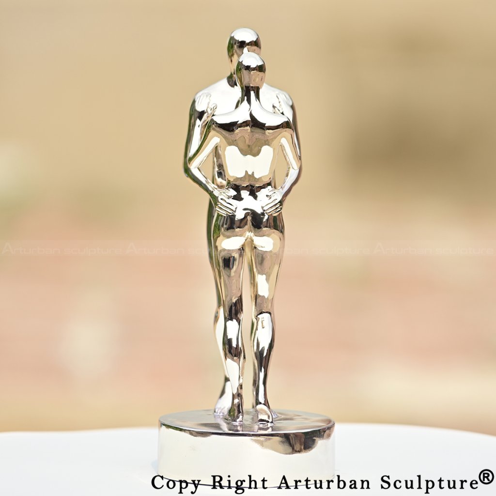 Detailed look at In Every Lifetime I Will Find You sculpture, showcasing intertwined legs of embracing couple
