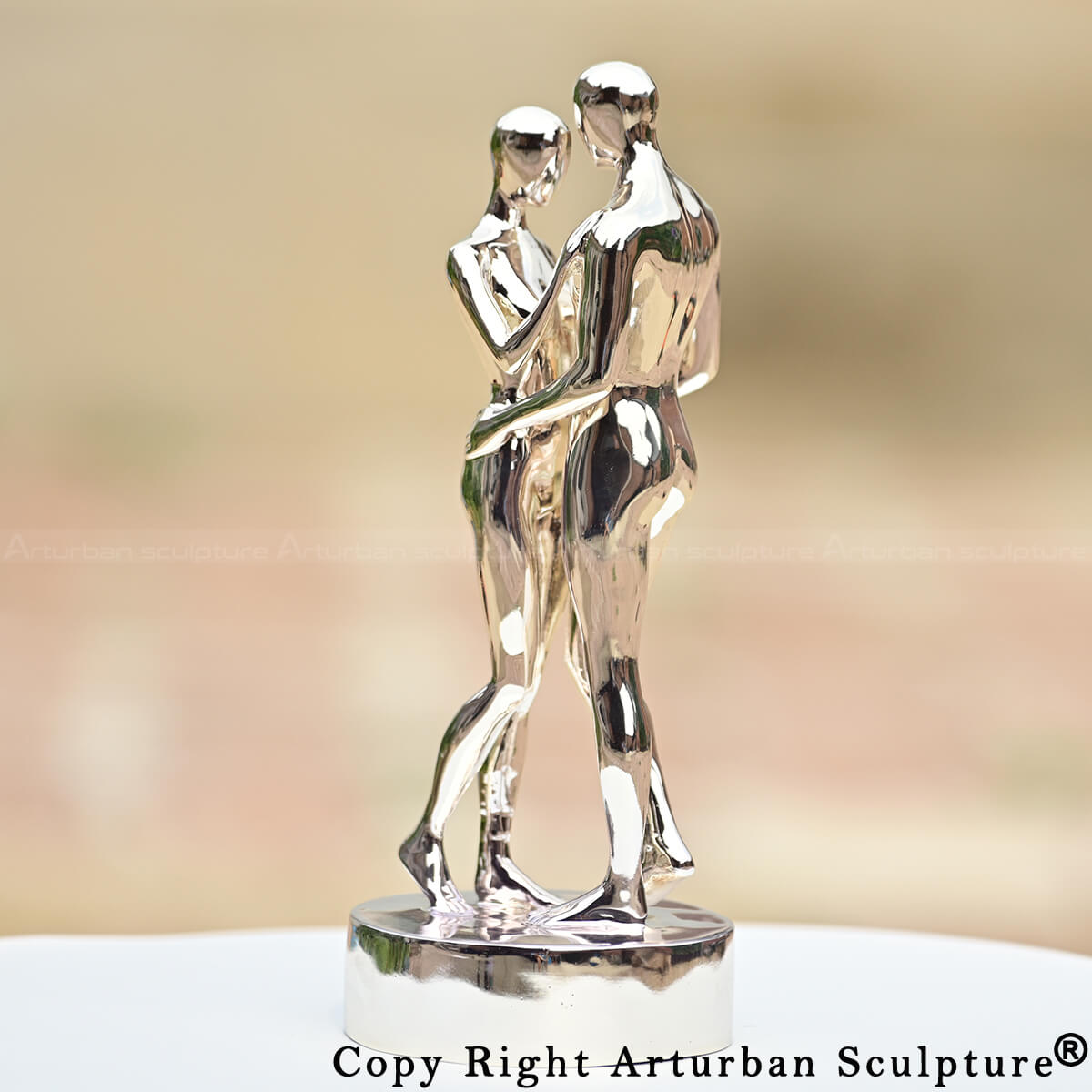 In Every Lifetime I Will Find You artwork, mirror-polished couple embracing statue close-up