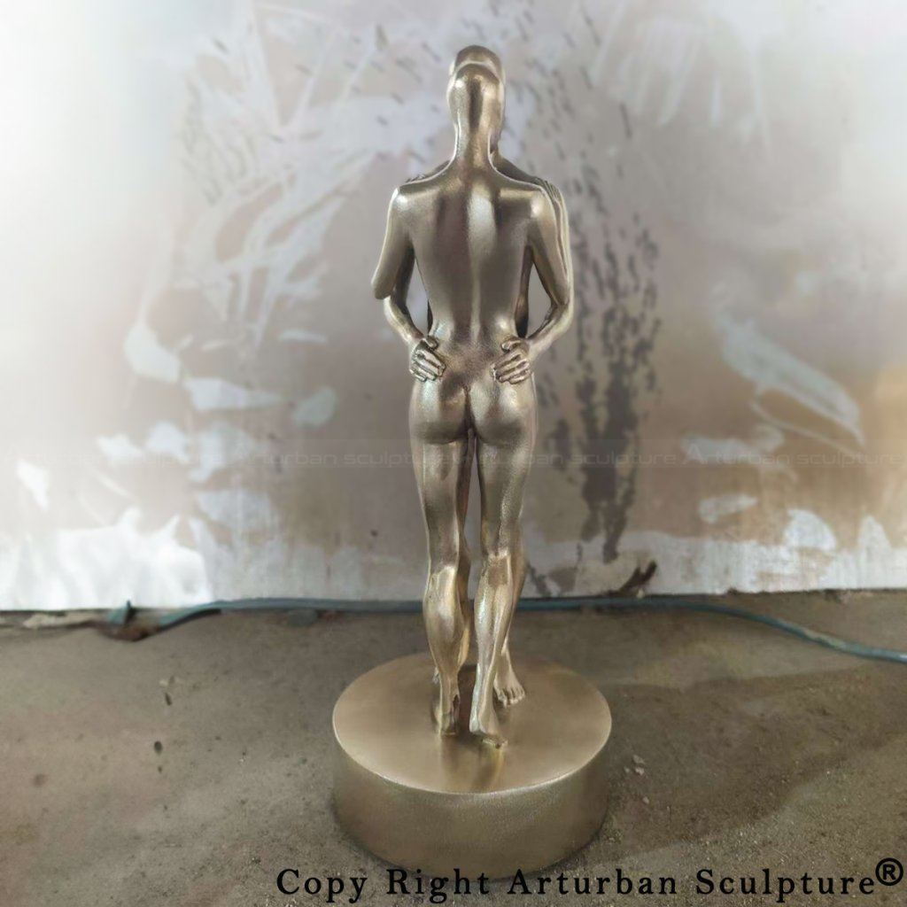 Electroplating stage of couple embracing statue, rear view of the female figure