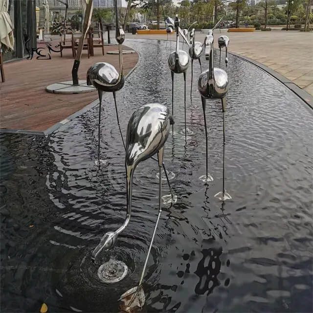 A graceful flamingo statue outdoor installation made of stainless steel