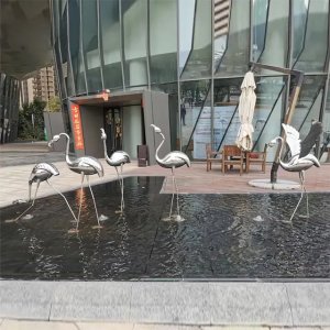 A modern flamingo statue outdoor artwork shows stylized stainless steel flamingos with elongated legs