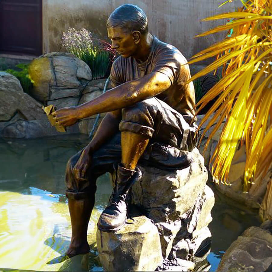 Bronze sculpture of a soldier reading a letter