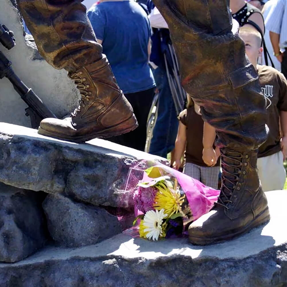Close-up of a soldier statue for garden featuring bronze combat boots