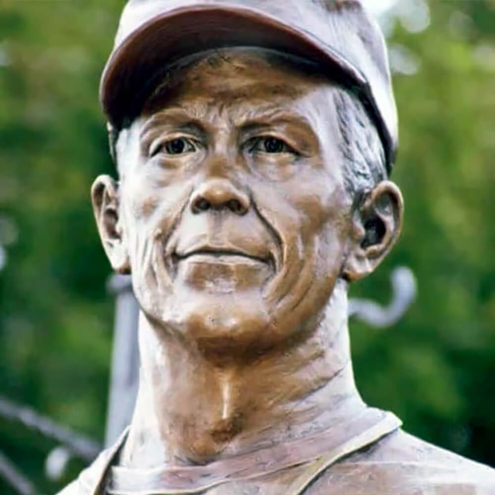 Headshot of Don Requa Coach Statue in bronze, showing calm and focused expression