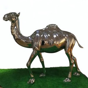 Large camel statue made of stainless steel displayed on green grass