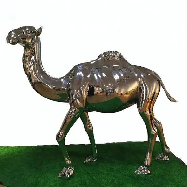 Large camel statue made of stainless steel displayed on green grass