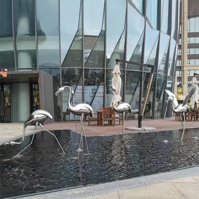 Multiple stainless steel birds form a flamingo statue outdoor display