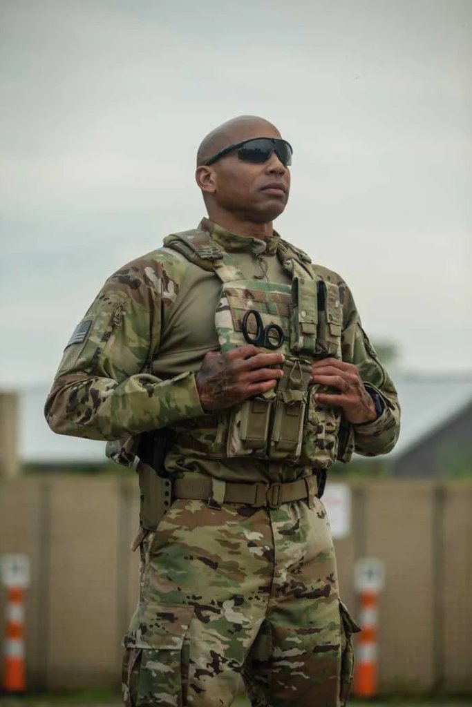 U.S. soldier in OCP uniform and tactical vest standing confidently