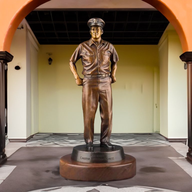 bronze Admiral Nimitz Statue standing on a round pedestal, honoring WWII Navy leader