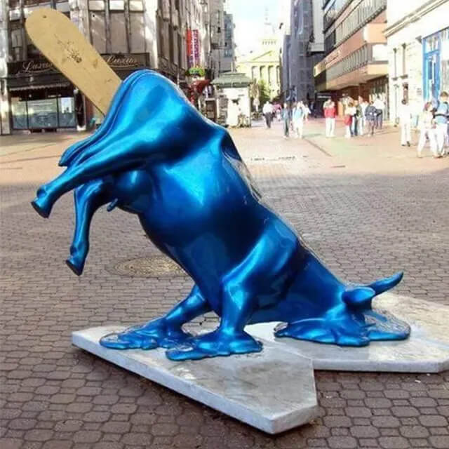 Glossy blue Melting Cow Statue with a popsicle stick top