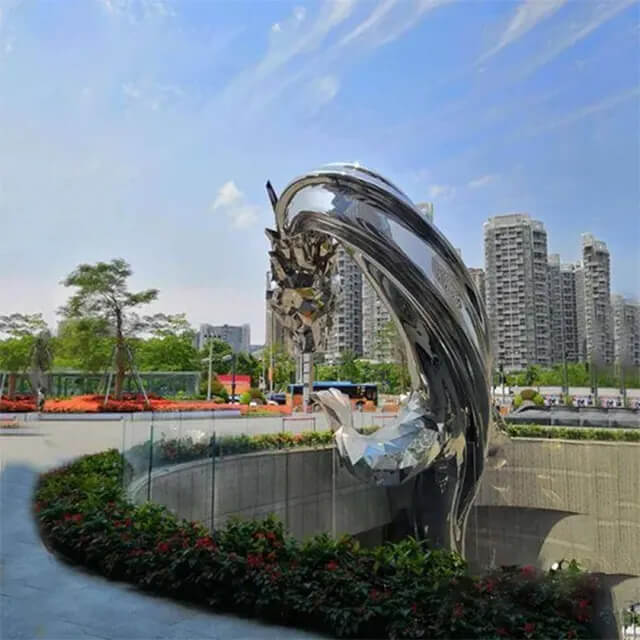 Polished Stainless Steel Dragon Sculpture rising from an urban garden