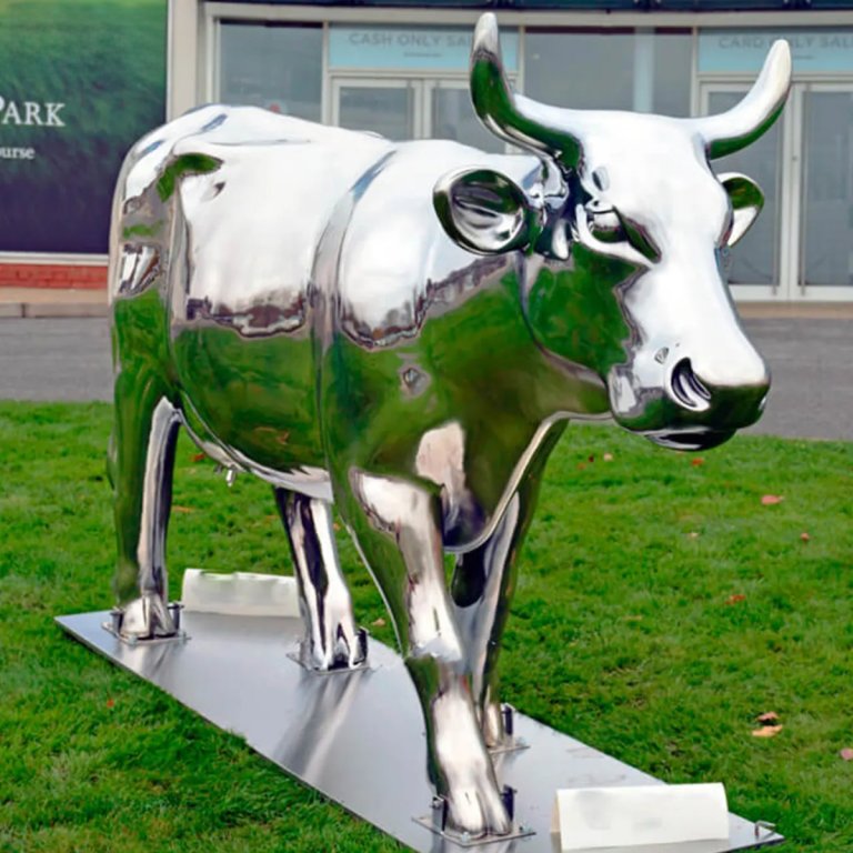 Stainless Steel Bull Statue with a mirror-polished surface and powerful walking posture, ideal for outdoor public art