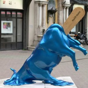 Stainless steel Melting Cow Statue resembling a melting ice cream bull