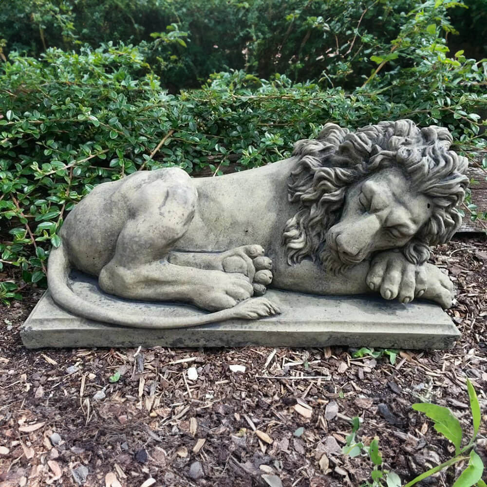A Sleeping Lion Sculpture made of stone with detailed mane