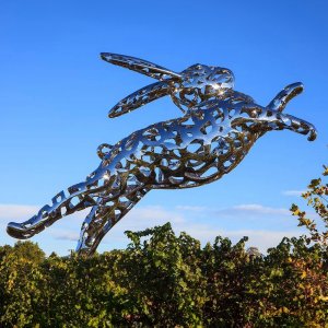 A large Bunny Foo Foo Statue made of stainless steel with a hollow design, showing a leaping rabbit