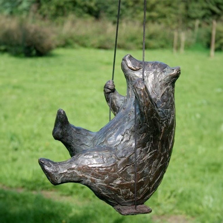 Bronze Playful Bear Statue for Sale featuring a cheerful bear on a swing