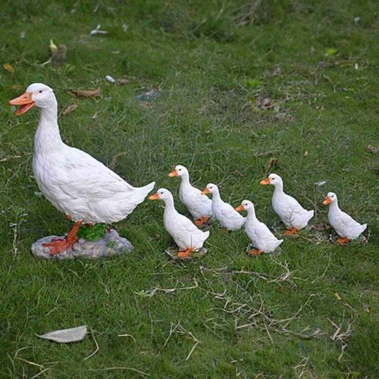 Duck Family Lawn Ornaments made of fiberglass showing a mother duck leading her ducklings