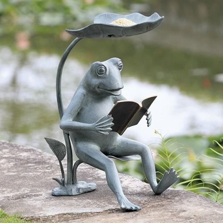 Frog Reading Book Statue in bronze sitting under a leaf while holding a book