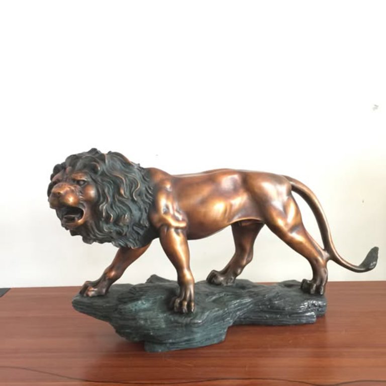 Male Lion Statue bronze artwork standing on a rock base with roaring expression