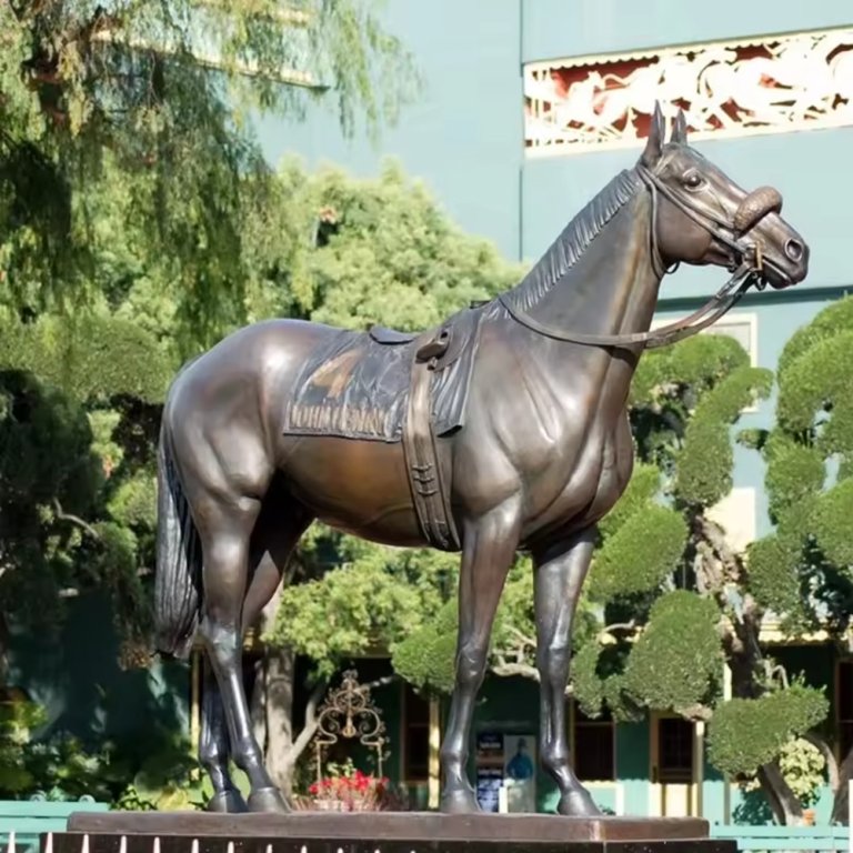 Outdoor bronze Racehorse Statue depicting a Thoroughbred with detailed saddle and strong muscular build