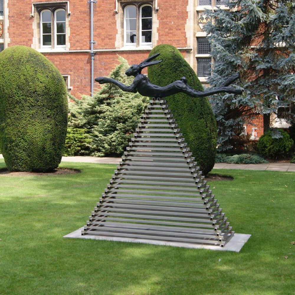 Running Hare Sculpture in bronze leaping over a pyramid-shaped base