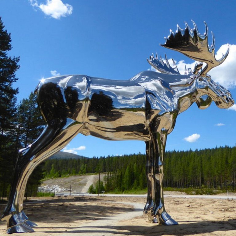 The Big Elk Statue in stainless steel, giant moose sculpture reflecting sky and forest in Norway
