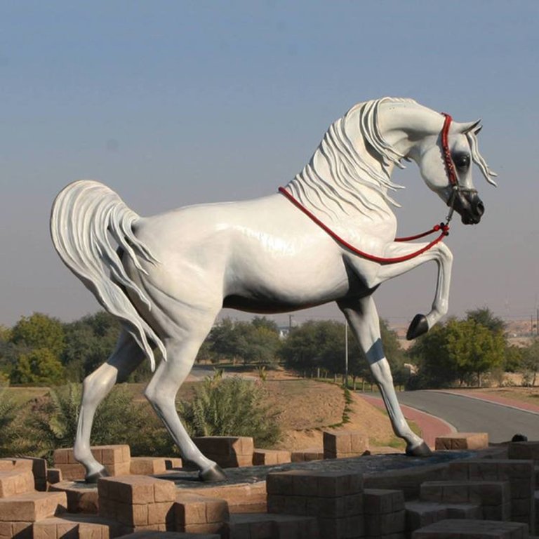 White Arabian Horse Statue bronze sculpture showing a majestic horse with raised leg and flowing mane