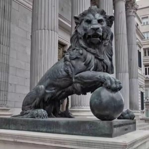 bronze Lion Gate Statue depicting a majestic lion with one paw resting on a ball