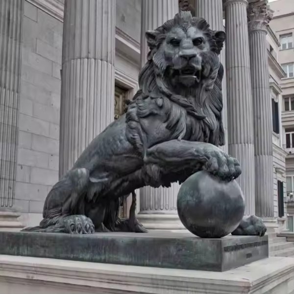 bronze Lion Gate Statue depicting a majestic lion with one paw resting on a ball